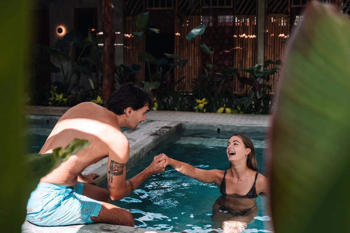 Hesa Spa Sandat couple laughing by the plunge pool at twilight, Ubud Bali
