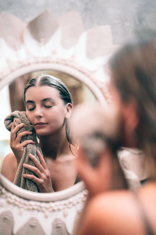 Hesa Spa Sandat woman at vanity with sun mirror after treatment, Ubud Bali