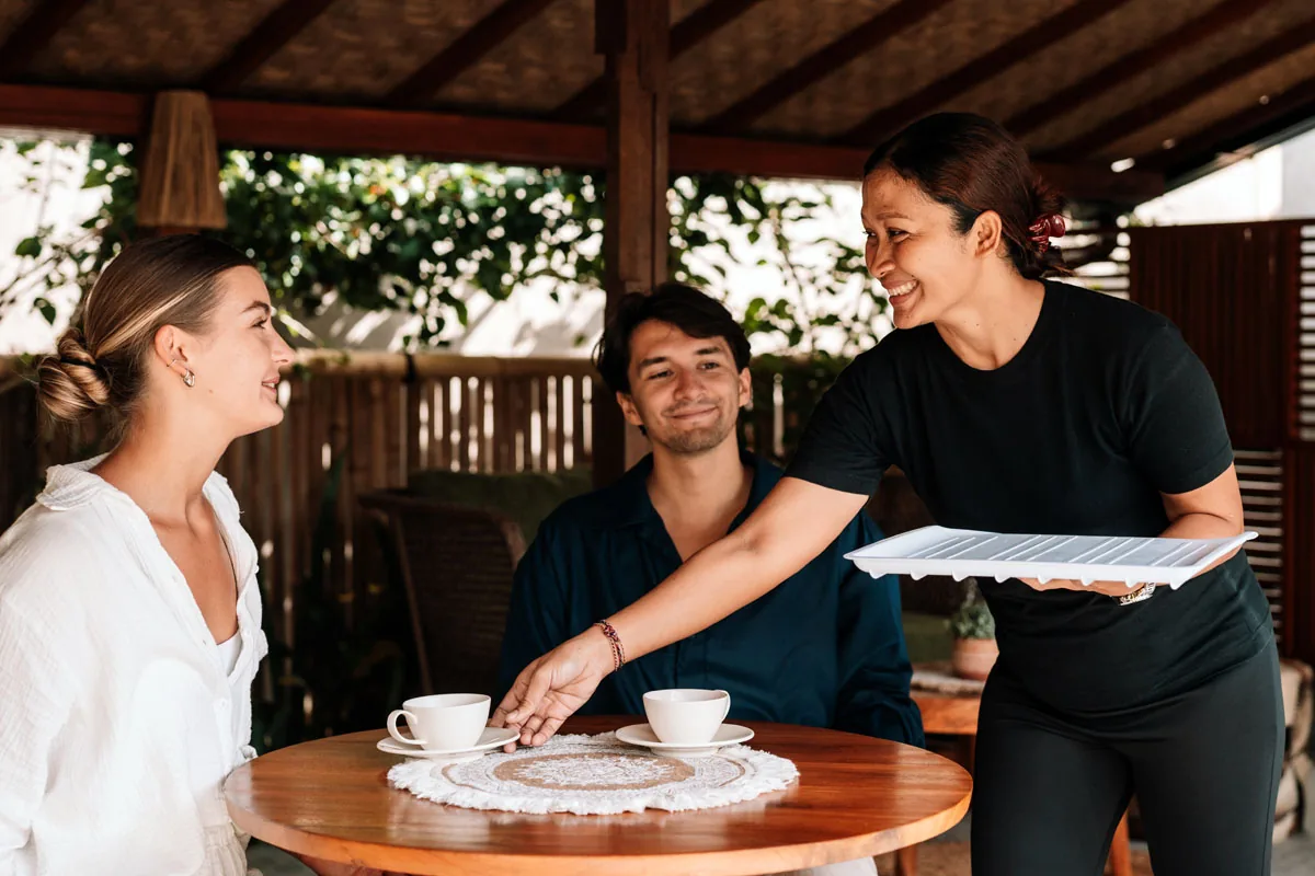 Hesa Spa Sandat therapist serving welcome tea to a couple, Ubud Bali